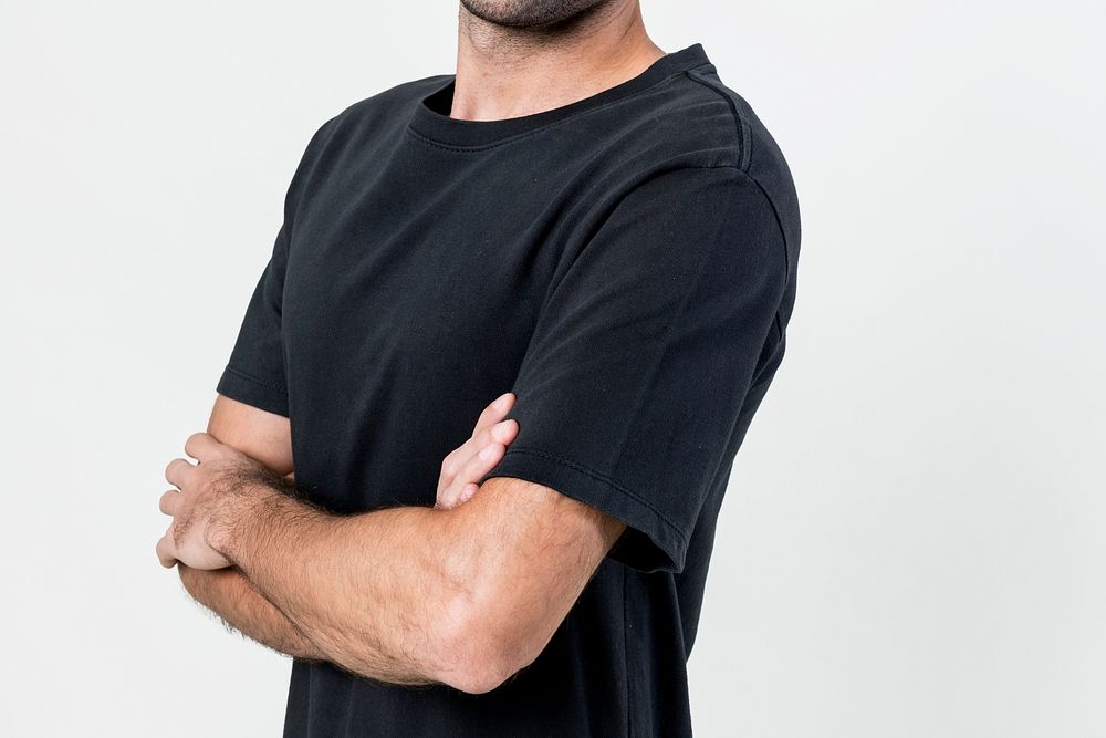 Man wearing black t-shirt with arms crossed