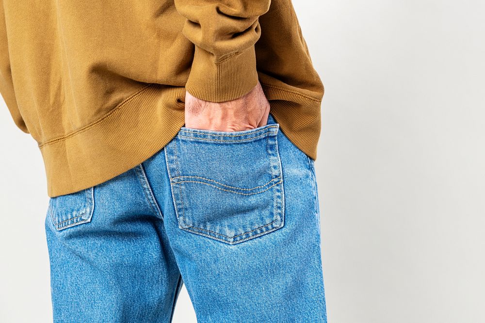 Man put his hand into back pocket of jeans