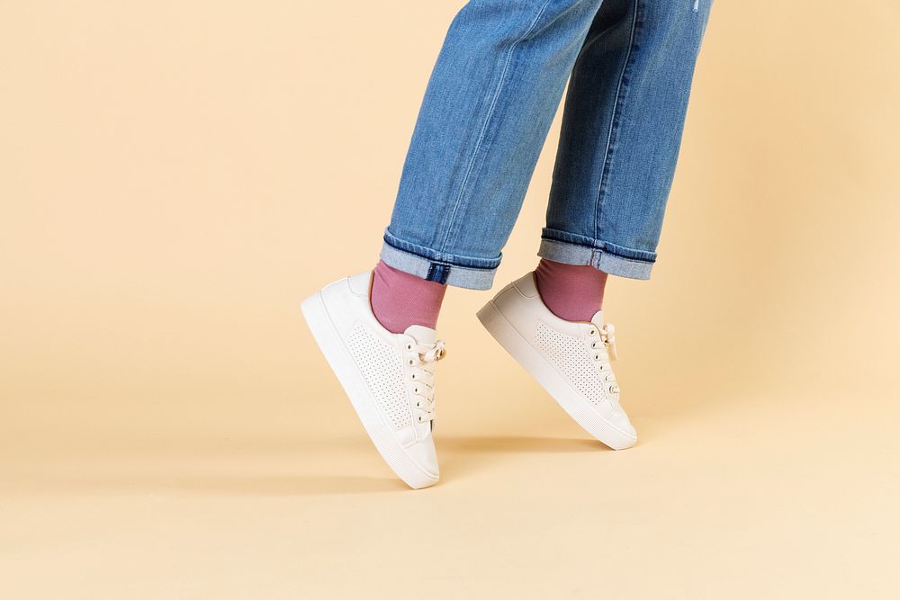 Woman wearing jeans and white sneakers 