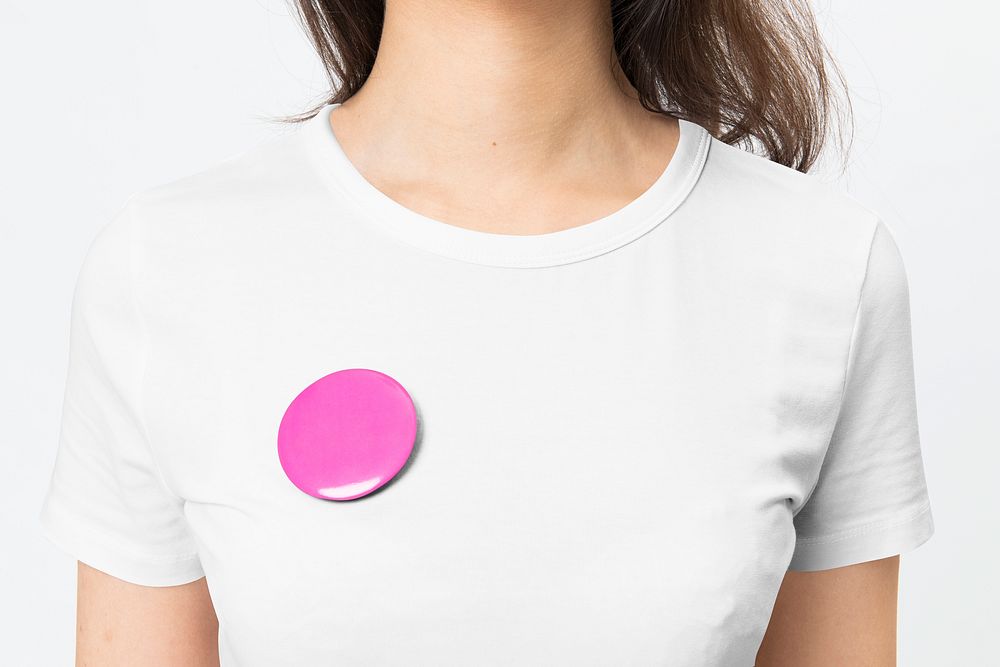 Pink empty badge pin on woman&rsquo;s t-shirt with design space