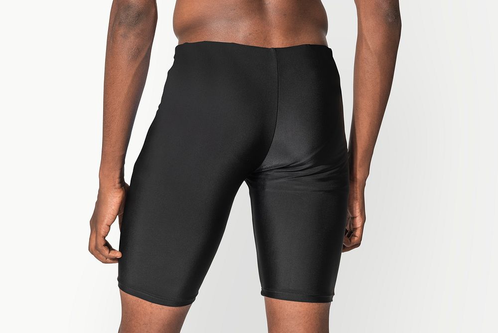 Man in black compression shorts for swimwear fashion shoot rear view