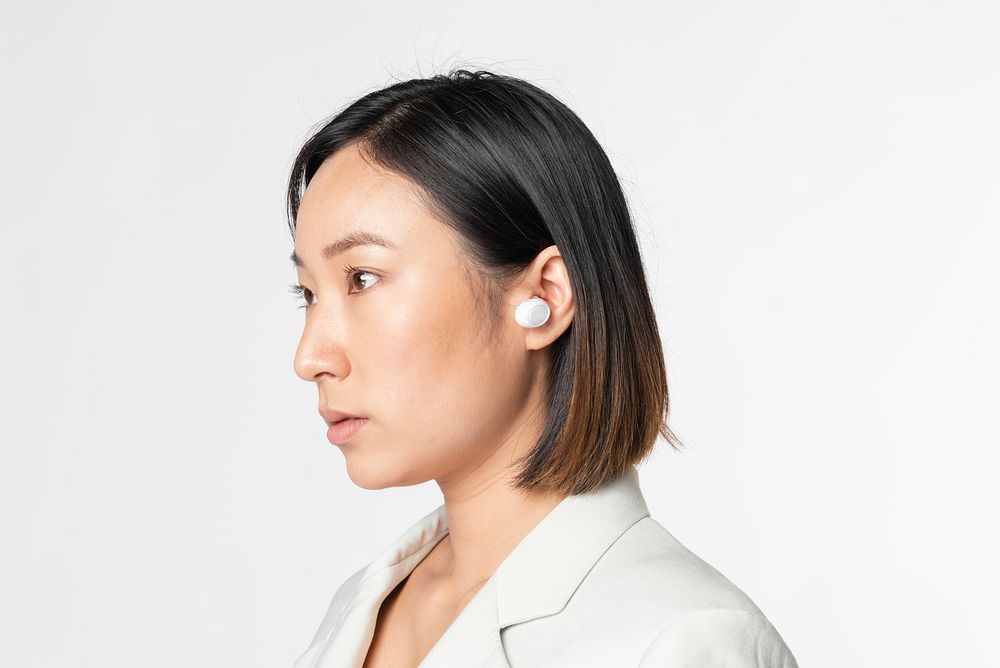 Businesswoman with smart wireless earbuds futuristic communication