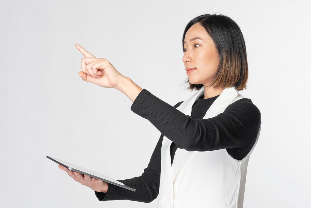 Businesswoman touching invisible screen futuristic technology