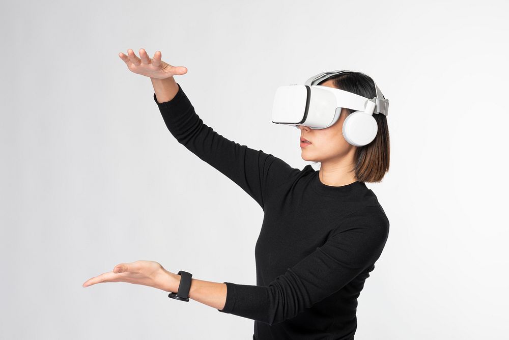 Woman with VR touching invisible object