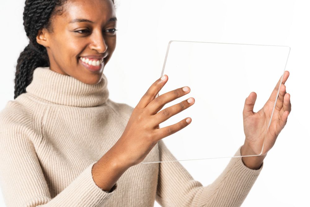African American woman using transparent digital tablet
