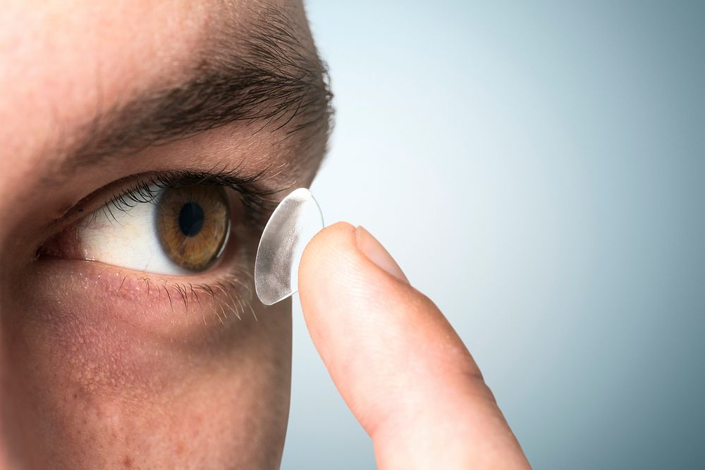 Man applying contact lens psd mockup biometric technology