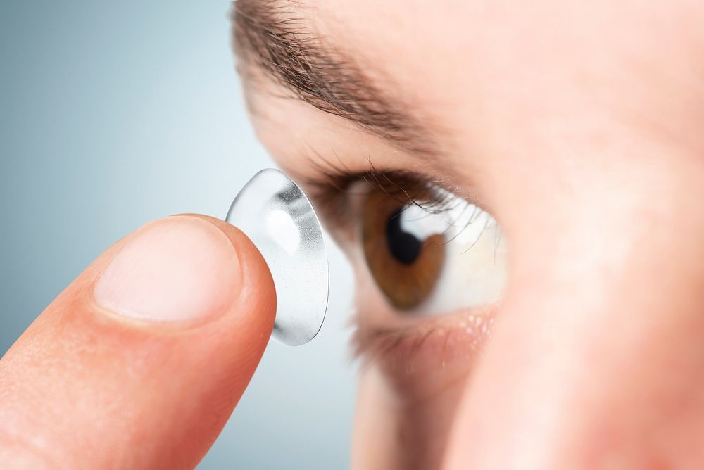 Man psd mockup applying smart contact lens biometric technology