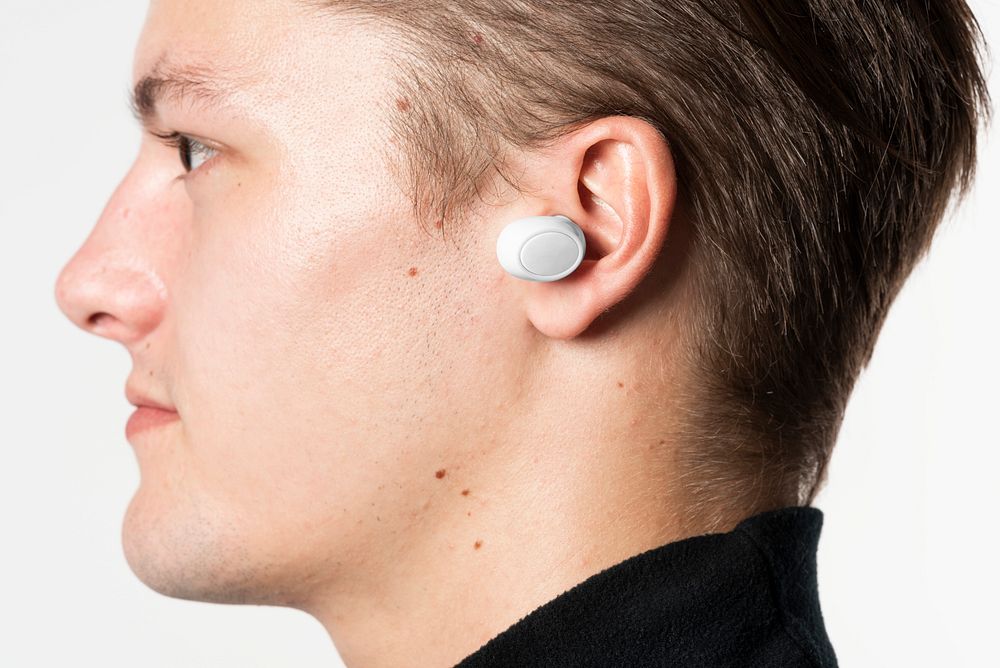Wireless earbuds in young man&rsquo;s ear