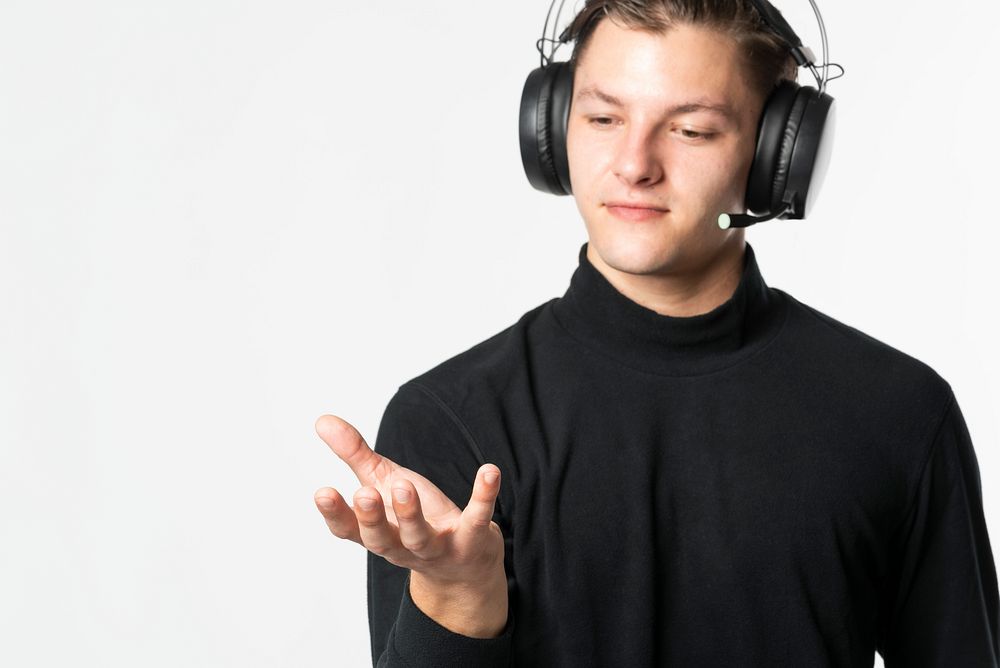 Telemarketer man with smart headphones showing invisible object
