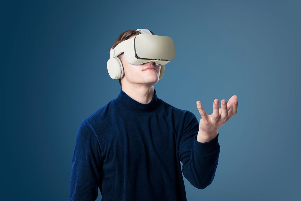 Man with VR headset touching invisible object smart technology