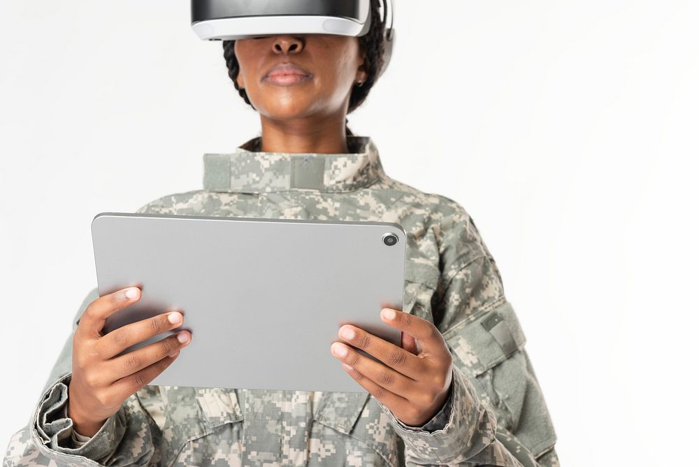 Female military wearing VR headset using tablet