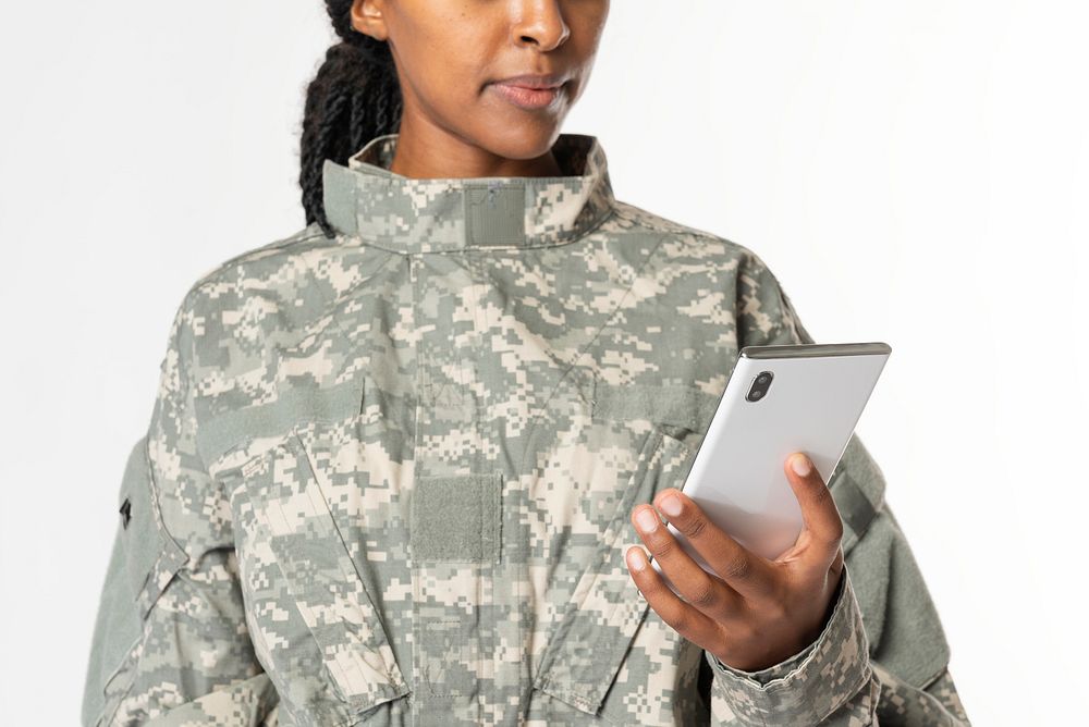 Female soldier carrying a smartphone 