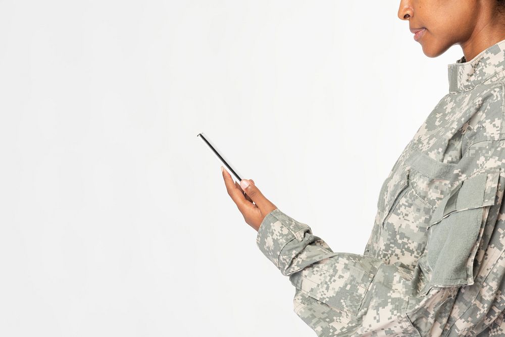Female soldier in a uniform holding a phone