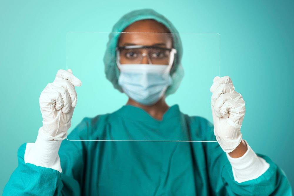 Doctor holding futuristic transparent tablet screen with design space