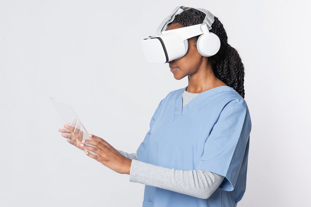 Doctor in VR glasses with medical uniform working on transparent tablet