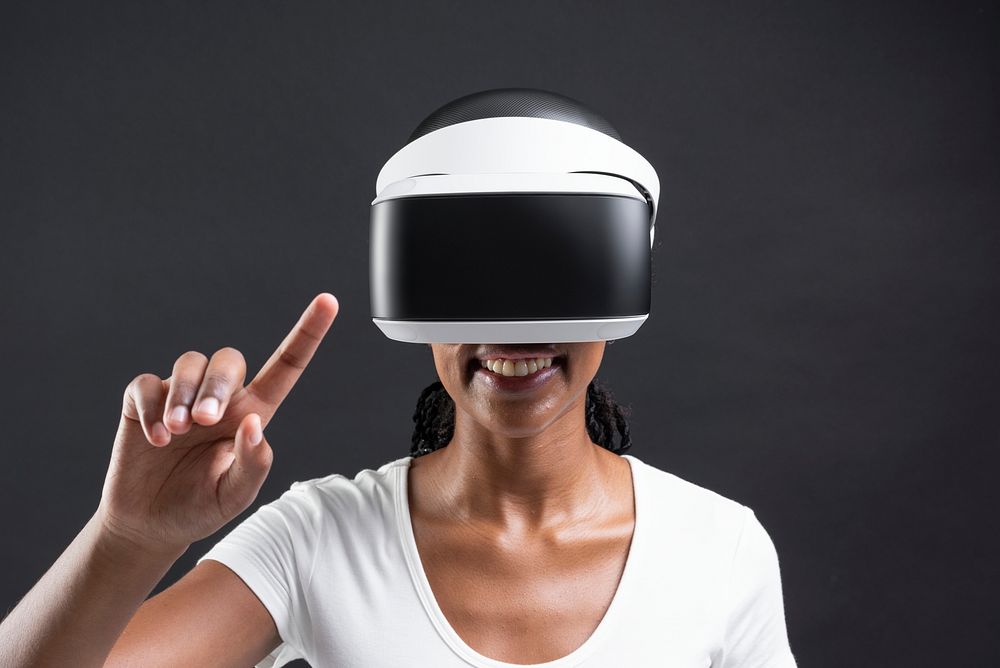 African American woman playing a virtual video game on virtual screen