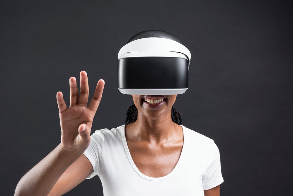 Woman with VR headset touching invisible screen