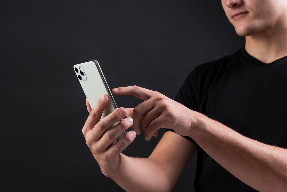 Young man pointing at the smartphone's screen