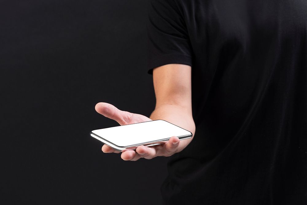 Man showing a smartphone on his hand