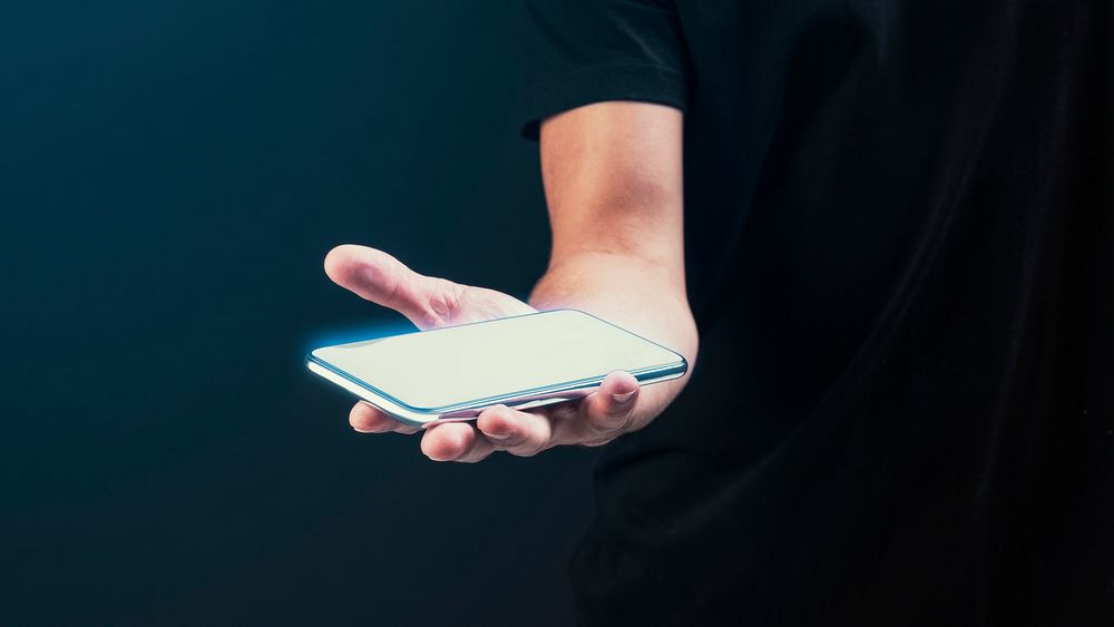 Man showing a smartphone on his hand