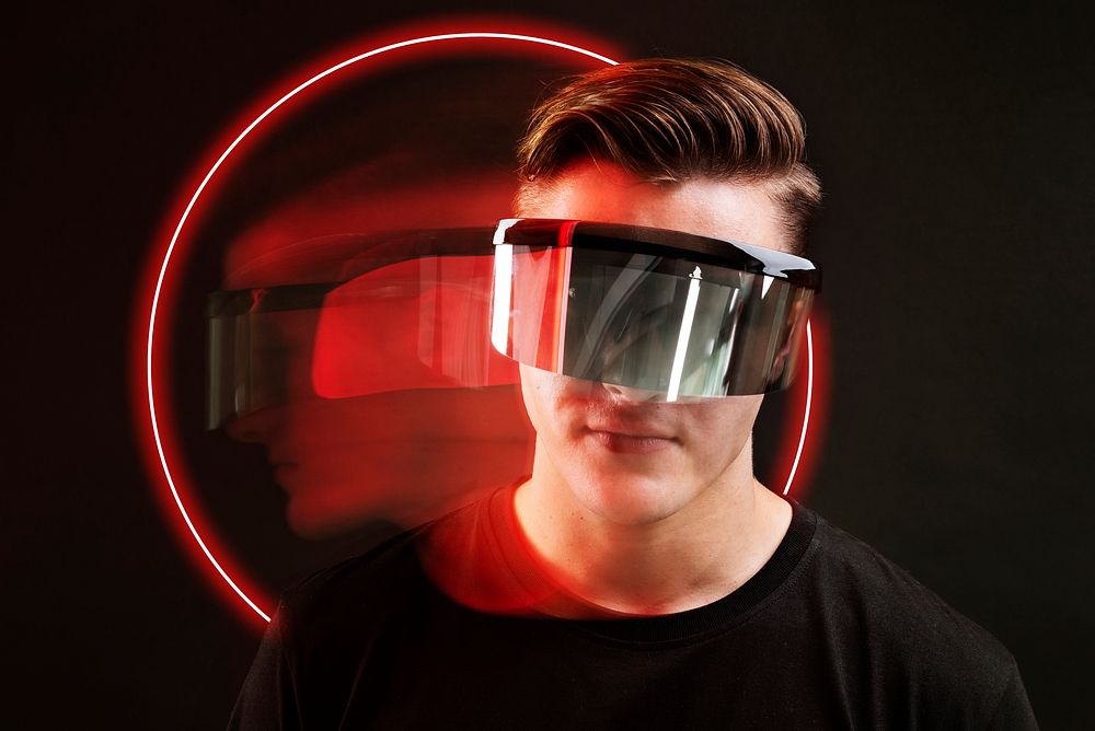 Man playing games with vr goggles technology background