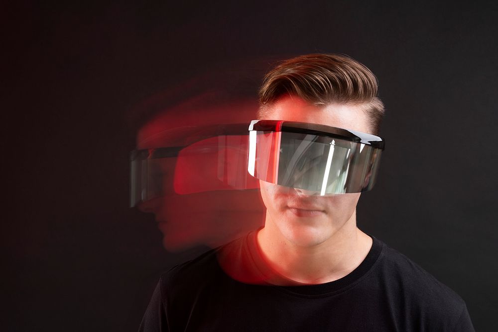 Man playing games with vr goggles technology background