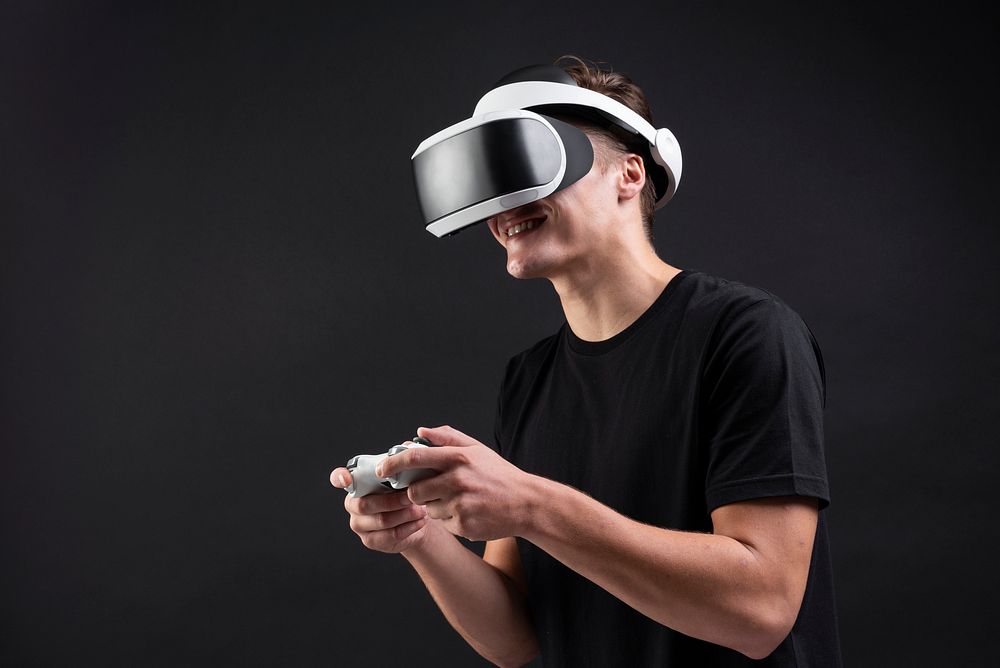 Man in VR headset playing game with a wireless controller  entertainment technology