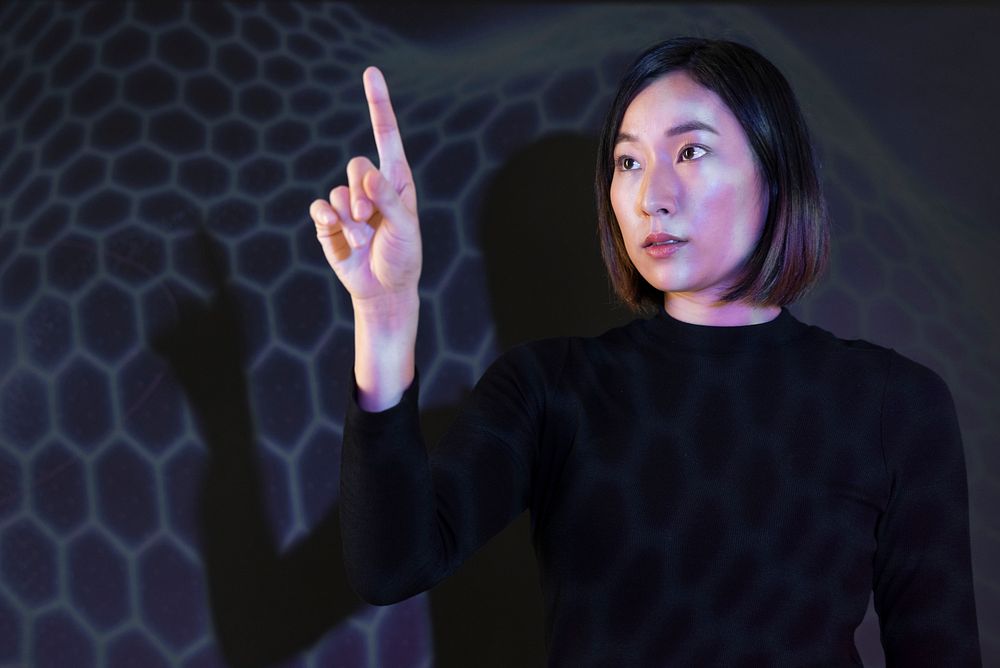 Businesswoman touching virtual screen futuristic