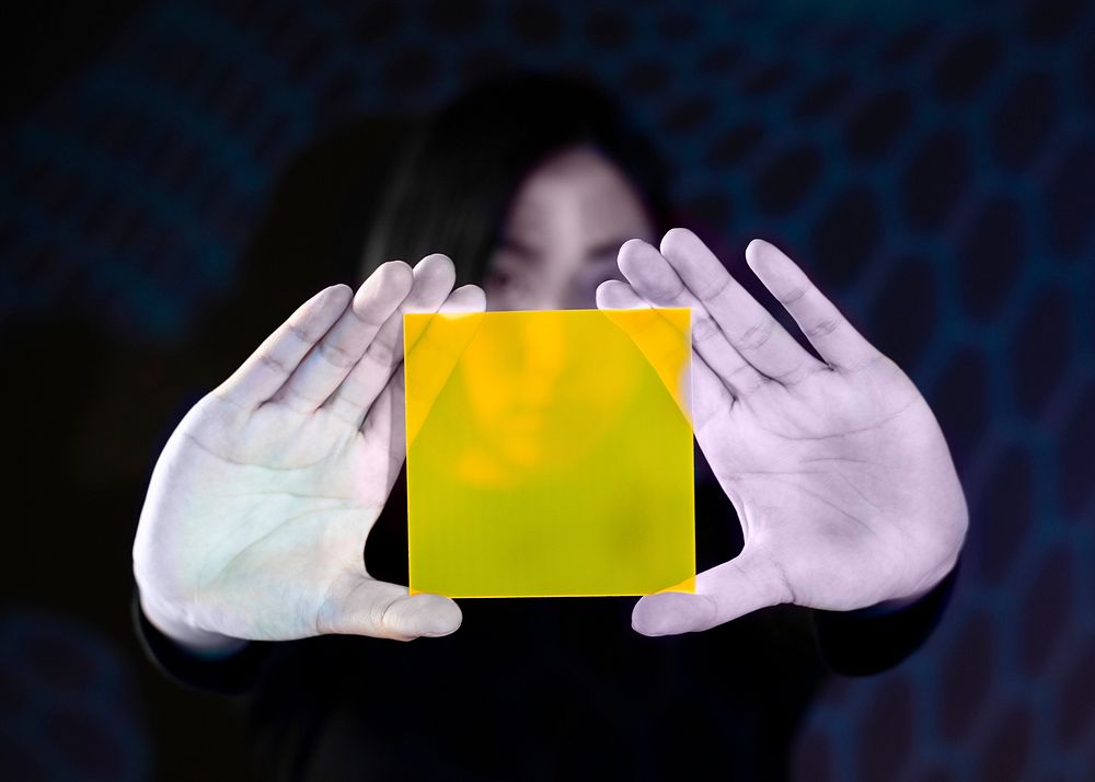Woman showing yellow interface hologram