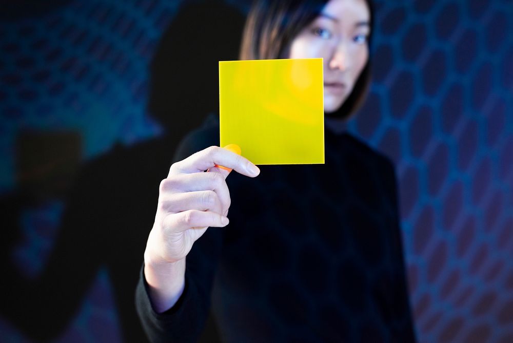 Woman showing yellow interface hologram