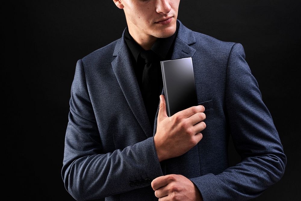 Businessman in suit holing his smartphone