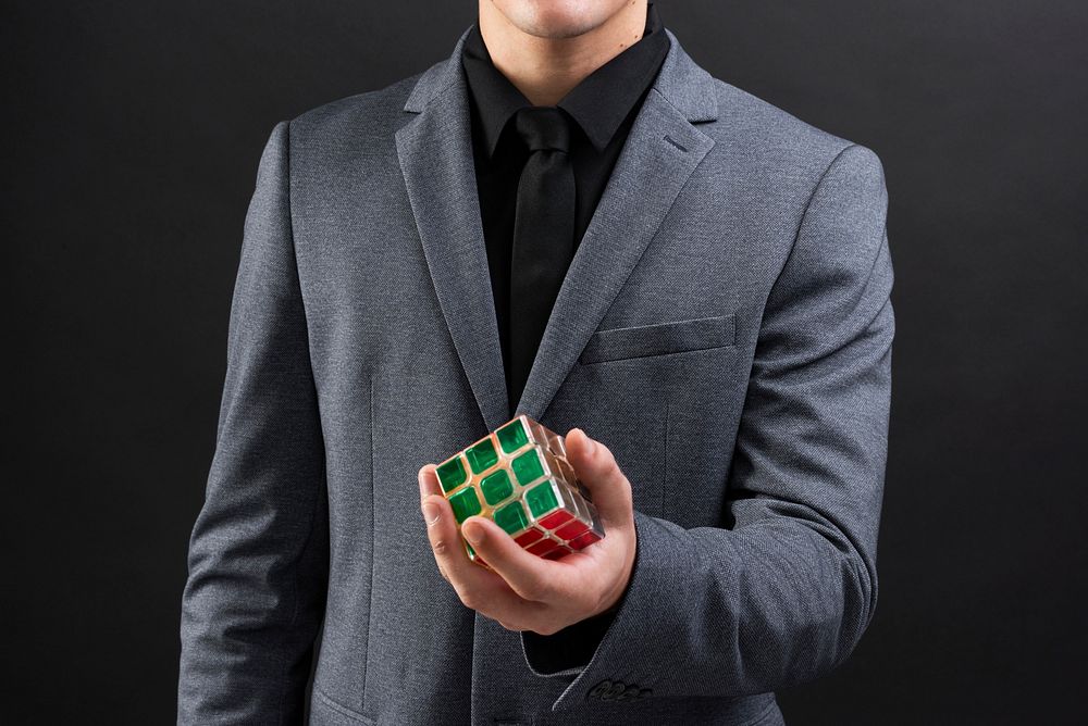 Businessman holding innovative combination puzzle cube 