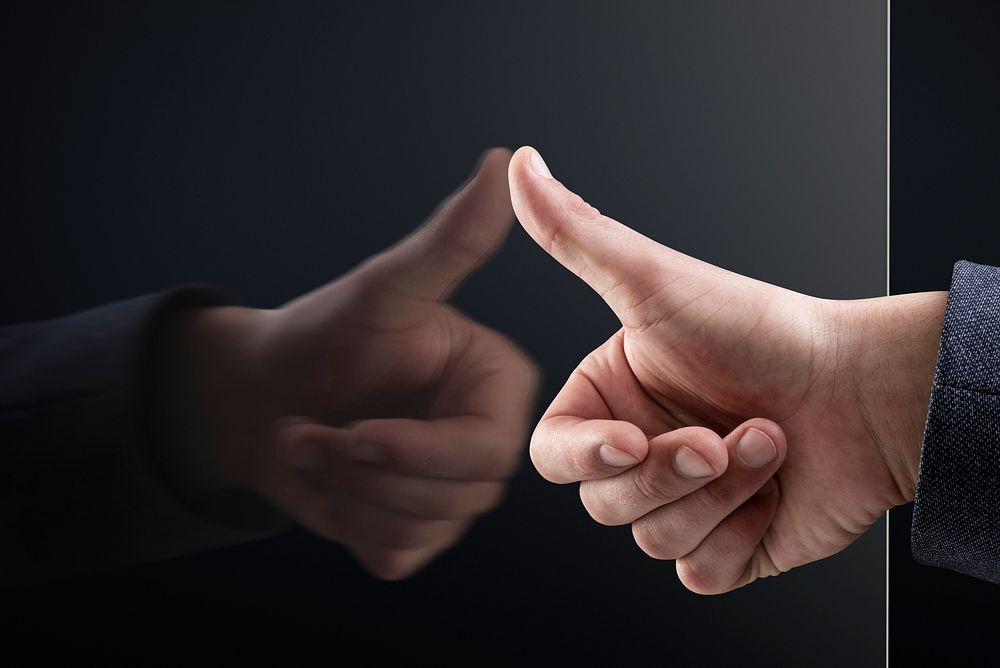 Man pressing thumb on transparent screen