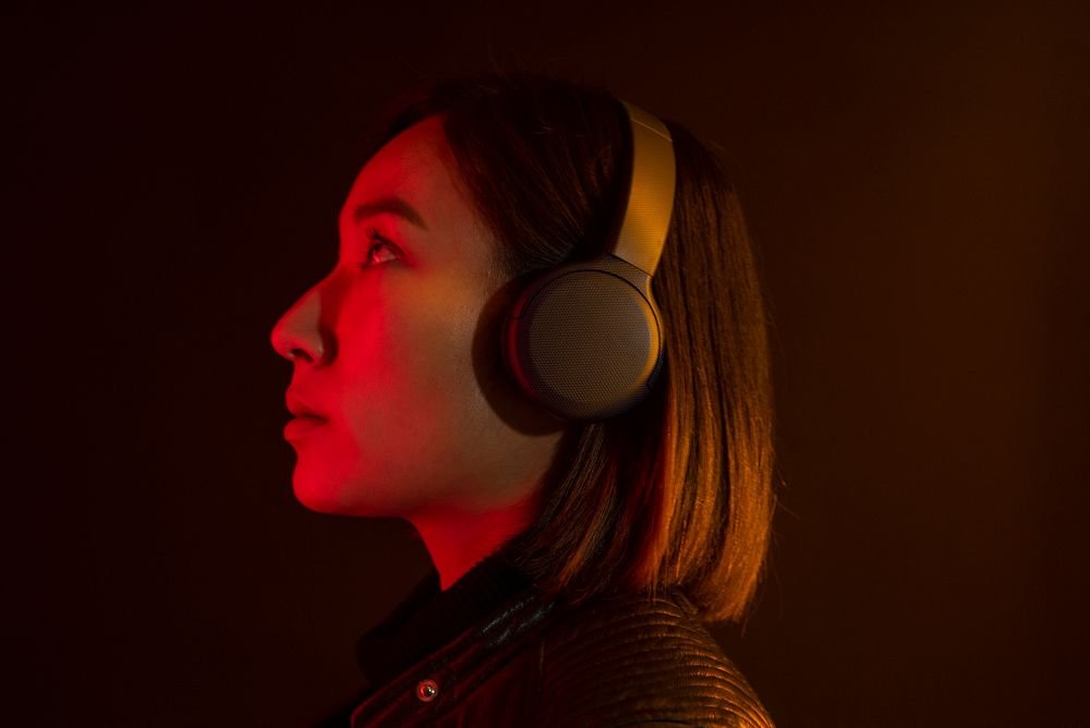 Asian woman listening to music with wireless headphones