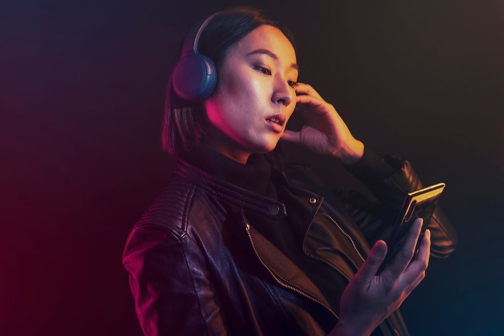 Woman listening music on mobile phone