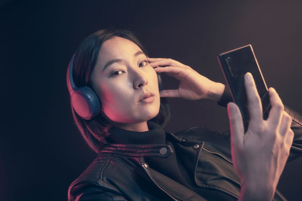 Woman to listening music with wireless headphones
