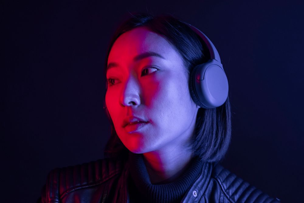 Woman listening to music with wireless headphones