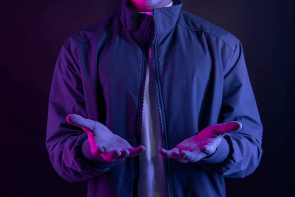 Man with hand gesture  purple light portrait