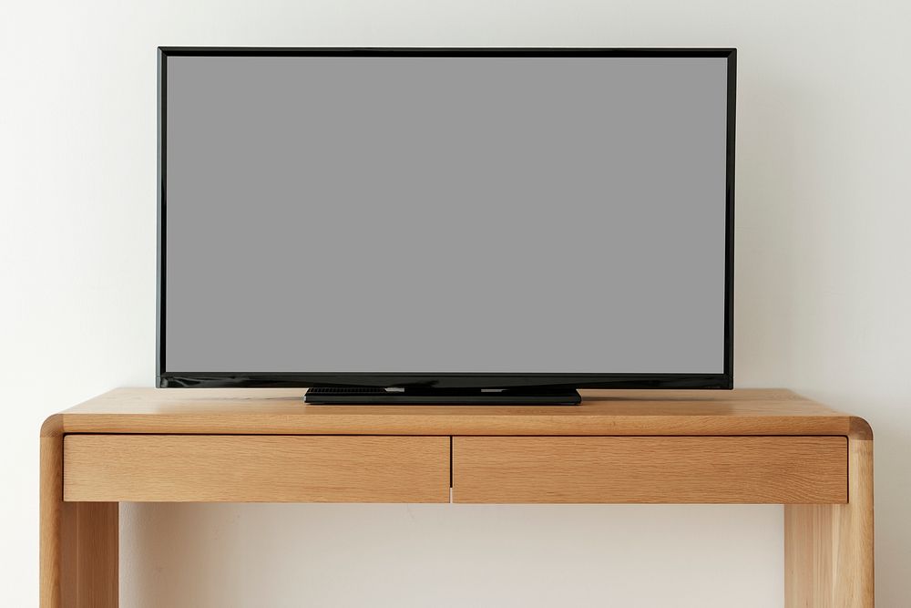 Smart TV screen mockup psd on a wooden table