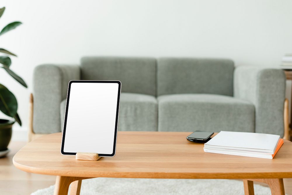 Digital tablet white screen mockup psd on a wooden table