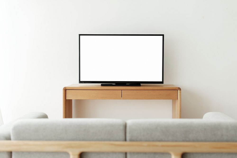 Blank white smart TV screen on a wooden table