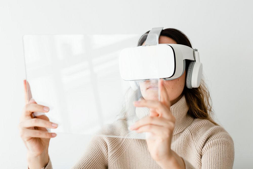 Woman experiencing VR simulation with transparent tablet