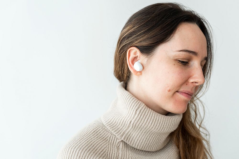 Woman wearing white wireless earbuds