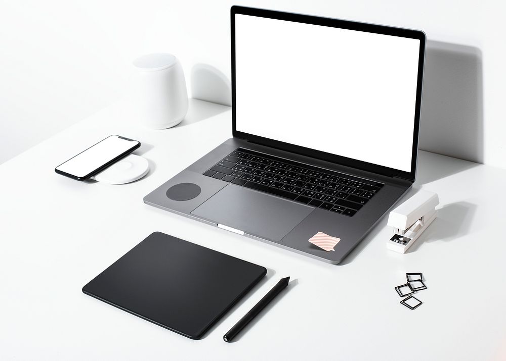 Laptop screen mockup psd on a white table