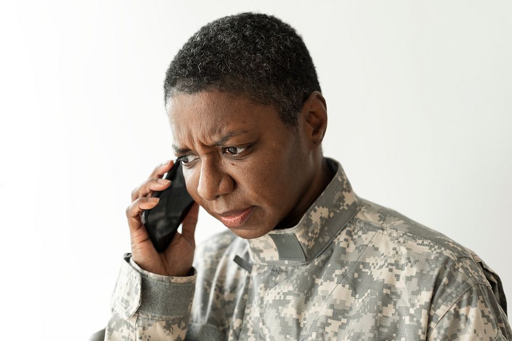 Female soldier talking on a smartphone communication technology