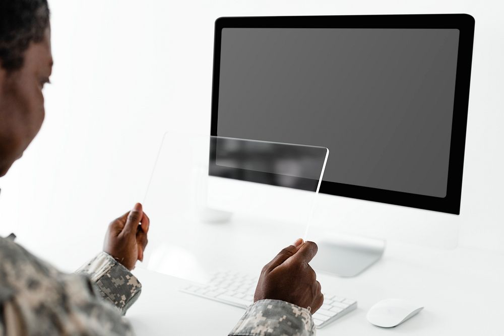 Military officer holding transparent tablet screen