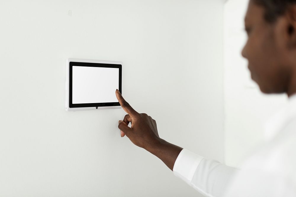 Woman pressing on smart home automation panel monitor