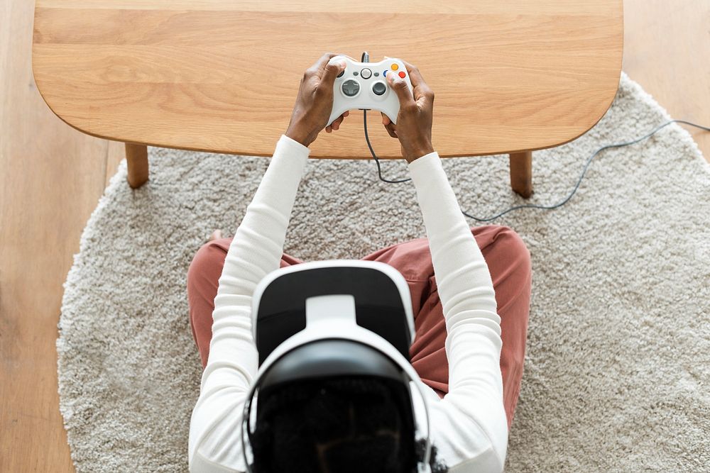 African man experiencing VR simulation and holding a gaming controller