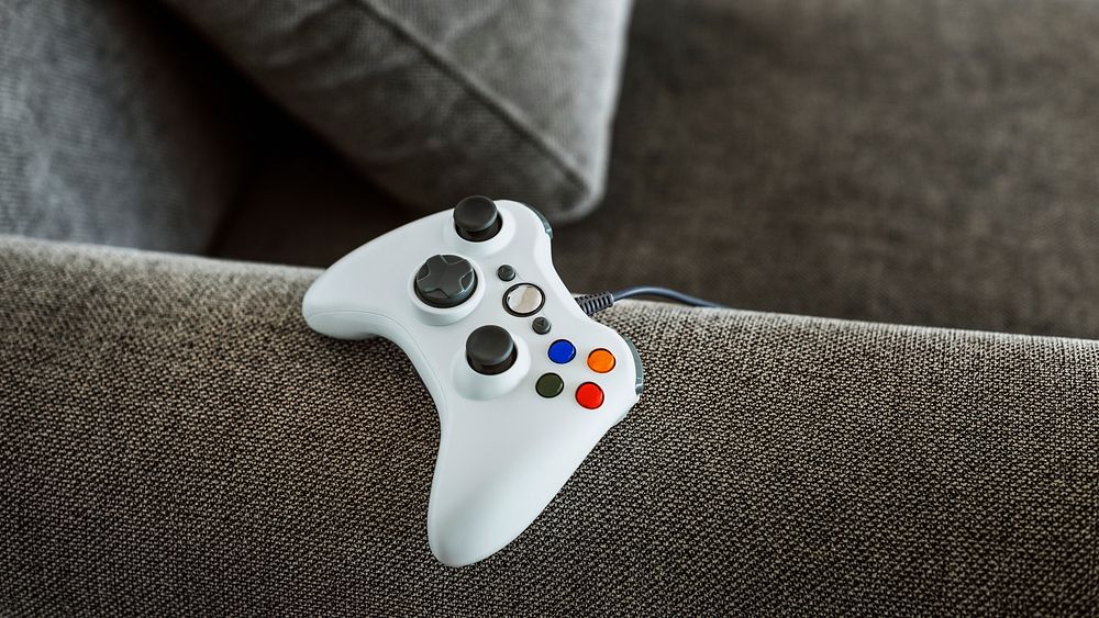 White gaming controller on a sofa