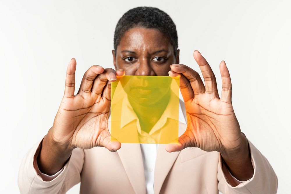 Woman presenting yellow transparent plate advanced technology